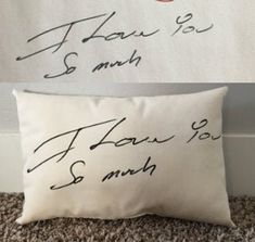 two pillows with writing on them sitting next to each other