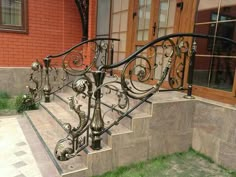 a wrought iron stair rail on the side of a house