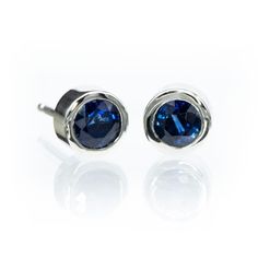 Simple blue sapphire bezel set stud earrings. SAPPHIRE: Lab-created blue sapphires or genuine mined blue sapphires 3.5mm or 4mm Round Faceted cut (other sizes available upon request) Select from 2 grades of genuine sapphires: Grade A: Medium to dark navy, little or no color zoning; slightly included; good brilliance; good cut; good polish Grade AA: Medium navy to royal blue; eye clean; good brilliance; good cut; good polish The studs measure 5.5mm diameter with the 4mm sapphires. Pictures show 4 Modern Sapphire Jewelry With Polished Finish, Sapphire Jewelry With Round Bezel Setting, Sapphire Jewelry With Bezel Setting In Round Shape, Elegant Sapphire Earrings With Polished Finish, Modern Bezel Set Earrings For Formal Occasions, Modern Formal Earrings With Bezel Setting, Blue Bezel Set Earrings For Formal Occasions, Formal Sapphire Earrings With Ethical Diamonds, Modern Sapphire Gemstone Earrings