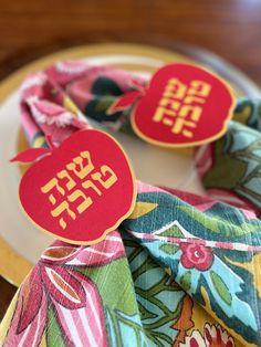 a close up of a plate with napkins on it and two tags that say sale