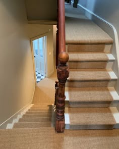 the stairs are made of wood and beige carpet