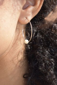 These timeless pearl hoops are made by hand and have a slight irregularity. Wear this classic shape daily or for a night out on the town. These make a great gift, easily worn for years by earring wearers of all ages and tastes. A variation of our Classic Hoops with a pearl. Product Details: -Available in solid sterling silver or 14k gold fill -Hammered 1.25in hoop with a hook clasp sold as a pair. -Pearl is an AAA-grade freshwater pearl that measures 5-6mm. All items are hand made to order, thus Small Hoop Pearl Earrings For Everyday, Modern Pearl Hoop Earrings As Gift, Everyday Round Pearl Earrings, Everyday Small Hoop Pearl Earrings, Small Pearl Hoop Earrings For Everyday, Everyday Small Hoop Pearl Drop Jewelry, Dainty Small Hoop Pearl Earrings For Everyday, Silver Small Hoop Pearl Earrings For Everyday, Sterling Silver Hoop Earrings With Pearl Drop For Everyday