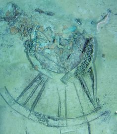 an aerial view of a chair in the middle of some dirt and sand with writing on it