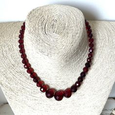 This is a beautiful antique graduated necklace with faceted red beads. The beads are untested, but two separate jewellers have identified them as a form of bakelite known as 'cherry amber'. This necklace is from circa 1920s/ 1930s, the Art Deco period. Clasp: spring ring Necklace Length: 39cm (15 inches) Beads: Between 1.7cm - 0.5cm wide Total weight: 20g Condition: Fairly good antique condition. The necklace looks to have been restrung so is slightly off centre. Would make a lovely gift! Free g Antique Beaded Necklace With Faceted Beads As Gift, Antique Beaded Necklaces With Faceted Beads As Gift, Antique Beaded Necklace With Faceted Beads For Gift, Vintage Faceted Beaded Necklaces For Gifts, Antique Red Beaded Necklaces For Gift, Vintage Crystal Necklaces With Polished Beads As Gift, Antique Red Beaded Necklace For Gift, Vintage Faceted Round Bead Necklaces, Vintage Crystal Necklaces With Polished Beads For Gift