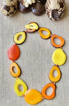 Handmade in Ecuador Necklace Length: 19.5 Inches Due to this item being handmade and the nature of the Tagua Nut the size and the color may vary from piece to piece Handmade Round Earthy Necklaces, Handmade Earthy Round Necklaces, Handmade Round Earthy Necklace, Unique Multicolor Teardrop Necklace, Handmade Unique Orange Necklaces, Unique Handmade Orange Necklaces, Artisan Orange Adjustable Necklace, Adjustable Orange Artisan Necklace, Handmade Adjustable Orange Necklace