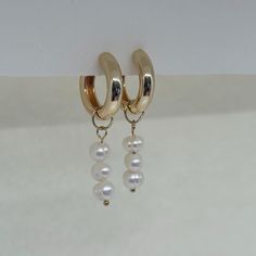 Beautiful earrings with freshwater pearls. The golden creoles add to her elegant look and the earrings go perfectly with an elegant outfit, but can also be worn every day. What makes our jewelry special? 🌊 The high-quality, gold-plated stainless steel makes the jewelry waterproof ✨ No discoloration, no green edges 🌿 Allergy-friendly 🫀 each piece of jewelry is selected with love and lovingly packaged 🤍 we do good! We donate part of our income to charitable causes and projects. We will keep yo Classic Gold Hoop Earrings With Pearl Charm, Classic Gold Hoop Pearl Earrings, Small Hoop Yellow Gold Pearl Earrings, Elegant White Huggie Jewelry, Small Hoop Pearl Earrings In Yellow Gold, Yellow Gold Pearl Small Hoop Earrings, Everyday 14k Gold Filled Pearl Pendant Earrings, Elegant Huggie Pearl Earrings, Minimalist Pearl Pendant Earrings For Anniversary