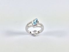 "Hi everyone, just wanted to let you know we are open and shipping daily. Beautifully crafted \"one of a kind\" contemporary Sterling Silver ring with genuine London Blue Topaz. The silver ring is finished with Rhodium so it will not tarnish. The gemstone used in this ring has been hand picked on a recent trip to Bangkok and is of a quality usually reserved for fine jewelry so you will almost never find such nice stones set in sterling silver! Weight 7.3 Grams This fine jewelry quality ring is p Fine Jewelry Blue Topaz Ring With Tension Setting, Blue Topaz Ring With Tension Setting, Modern Sterling Silver Topaz Ring For Formal Occasions, Modern Blue Topaz Ring, Round Shape, Modern Blue Topaz Round Ring, Modern White Gold Birthstone Ring With Accent Stones, Modern Round Blue Topaz Ring, Modern Silver Sapphire Ring With Accent Stones, Modern Solitaire Sapphire Ring