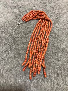 10 Strands Of Old Coral Beads From Morocco The Color is an Orange Red The little black spots in this coral are an indication of age Dimensions : the smallest bead is 3.9mm x 3.8mm the largest bead is 7mm x 6,7mm Length of Strand : 26cm Weight : 117g Traditional Coral Beaded Necklaces With Polished Beads, Orange Red Coral Beads For Jewelry Making, Traditional Red Coral Beaded Necklace With Colorful Beads, Traditional Coral Beaded Necklaces, Traditional Coral Gemstone Beads, Red Coral Beads For Jewelry Making, Large Red Coral Beads For Jewelry Making, Traditional Coral Beaded Necklaces With Colorful Beads, Red Coral Polished Beads For Jewelry Making