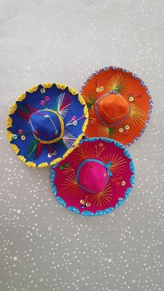 three colorful hats sitting on top of a table