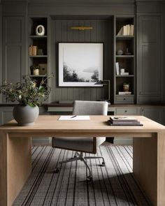 an office with gray walls and wooden desk