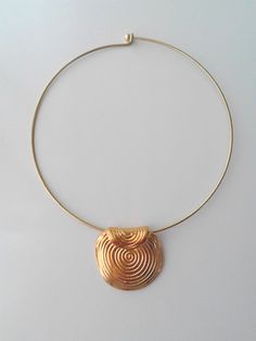 Beautiful minimalist necklace made with a gorgeous ethnic brass pendant, nickel free. It is a stunning piece, perfect to make everyone's attention turned on you. Contains no lead or nickel. Do not perfume over it or subject it to any liquid substances. I love the pure metal. But over time, metal will darken slightly, but when you rub stationery eraser, brilliance will return. The style of choker depending the availability. Composition: I always use natural materials, in this case real brass. The Minimalist Festival Jewelry With Pendant, Minimalist Festival Pendant Jewelry, Festival Brass Choker Necklace, Gold Circular Jewelry For Festivals, Gold Circle Jewelry For Festivals, Gold Circular Festival Jewelry, Minimalist Brass Jewelry With Large Pendant, Gold Minimalist Necklace For Festivals, Gold Pendant Choker For Festival