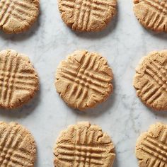 six peanut butter cookies on a marble surface