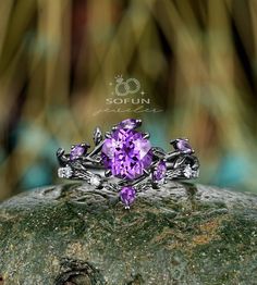 a purple ring sitting on top of a rock