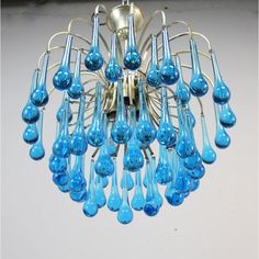 a chandelier with blue glass drops hanging from it