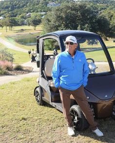 a man standing next to a golf cart