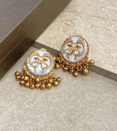 Polki earrings feature mother of pearl and Kundan work with an antique gold stud design. Perfect for Bollywood weddings, they showcase traditional Jadau craftsmanship, making them a stunning statement for Pakistani jewelry. *𝐏𝐑𝐎𝐃𝐔𝐂𝐓 𝐃𝐄𝐓𝐀𝐈𝐋* * Material: Brass * Plating: Gold Plated * Stone: Semi Precious Carved Stone & Polki. *𝐃𝐈𝐌𝐄𝐍𝐒𝐈𝐎𝐍𝐒* * Weight: 12 gm   * Length: 1.5 Inches, Width: 1.05 Inches Closure: PushBack. *𝐃𝐈𝐒𝐂𝐋𝐀𝐈𝐌𝐄𝐑* * Product color may slightly vary du Luxury Meenakari Temple Jewelry Pearl Earrings, Traditional 22k Gold Bridal Earrings For Festive Occasions, 22k Gold Meenakari Jhumkas For Wedding, Ornate Gold Kundan Chandbalis, Gold Meenakari Temple Earrings, Ornate Gold Chandbalis With Kundan, Ornate Kundan Gold Danglers, Ornate Gold Kundan Danglers, Traditional Gold Plated Cutdana Earrings