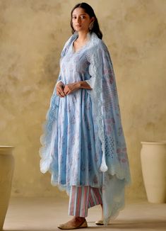 Features an blue leaf block printed cotton kurta with lace detailing on neck & sleeves along with pleats on side. It is paired with a strip printed palazzo and a dupatta with a wide cutwork lace border. Composition : Kurta: Mul Cotton Lined With Mul Cotton, Palazzo: Cambric Cotton, Dupatta: Mul Cotton Care: Dry Clean Only and Vacuum Storage All products can be customised for sleeves, length of blouse and neck design Delivery : 3-4 weeks as the product is hand crafted. Check Size Guide or choose MySize for free customisation (All Sizes above XL can be made at 15% additional cost) For more information and sizes please contact fabiliciousfashion@gmail.com or visit our Copenhagen studio. Blue Anarkali, Cotton Anarkali, Drape Saree, Palazzo Set, Designer Jumpsuits, Skirt Co Ord, Cotton Suits, Lace Border, Blue Leaves