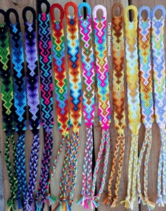 several different types of bracelets are lined up on a wooden table with scissors in them