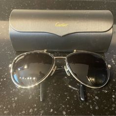 New, Never Worn Aviator Sunglasses. I Believe They’re Technically A Men’s Style But Look Livery Unisex. Comes With Case And Dust Cloth. Getting Rid Of Them Because They Were A Gift And I’m Just Too Hard On My Sunglasses To Wear A Designer Brand. Silver Aviator Sunglasses With Gradient Lenses For Outdoor, Silver Aviator Sunglasses With Metal Frame For Outdoor, Classic Cartier Sunglasses For Formal Occasions, Luxury Business Sunglasses With Tinted Lenses, Classic Silver Aviator Sunglasses For Outdoor, Elegant Aviator Sunglasses With Metal Frame For Formal Occasions, Modern Formal Aviator Sunglasses With Metal Frame, Elegant Silver Aviator Sunglasses With Mirrored Lenses, Classic Anti-reflective Sunglasses For Formal Occasions