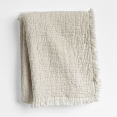 a white blanket with fringes on it