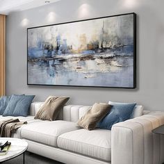 a living room filled with furniture and a large painting on the wall above it's couch