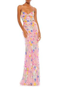 Turn heads at your next garden party in this spectacularly shiny gown adorned with sparkling sequins in pretty floral shapes and modern cutouts at the waist. 63" length V-neck Adjustable tie straps Lined 100% polyester Spot clean Imported Asian Owned/Founded Mac Duggal Prom, Sequined Gown, Body Hugging Dress, Sheath Gown, Cute Prom Dresses, Column Gown, Romantic Lace, Mac Duggal, Pink Sequin