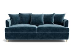 a blue couch with four pillows on it