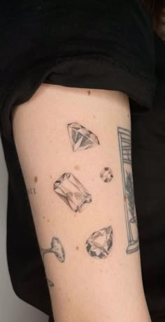 a woman's arm with diamond tattoos on it