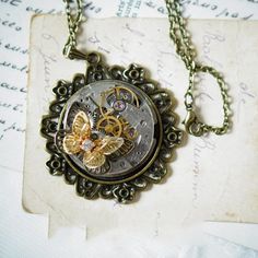 "Size:  Dial diameter: 1.19in Bottom bracket: 1.78in Necklace length: 27.6in PS.The movement is from an antique watch, not a complete timepiece, so it doesn't function. It exhibits normal signs of wear and tear. 🦋\"Dreams of the Butterfly\" Handcrafted Steampunk Necklace!  🦋Unleash the magic of yesteryear with our enchanting creation, \"Dreams of the Butterfly.\" This handcrafted steampunk necklace is a symphony of vintage elegance and mechanical allure, featuring a delicate fusion of watch mo Mechanical Butterfly, Steampunk Butterfly, Box Ribbon, Antique Watch, Vintage Steampunk, Steampunk Necklace, Retro Industrial, Butterfly Pendant Necklace, Antique Watches