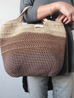 This crochet bag is a lovely handmade accessory that can be used to go grocery shopping, to go to the beach or to carry your stuff. It is an ideal gift for any occasion. This stylish shoulder bag offers plenty of room to store your things. It is opened at the top without inside lining Material: The bag is made out of 3mm polyester cord Cleaning and care: I recommend washing by hand with cold water and neutral soap. Leave to dry stretched out on a towel. Do not use a dryer machine. For more inten Brown Crochet Bag With Double Handle And Large Capacity, Trendy Handmade Beige Hobo Bag, Trendy Beige Crochet Bag For Shopping, Beige Crochet Shopping Bag With Braided Handles, Trendy Beige Crochet Shopping Bag, Large Capacity Bucket Crochet Bag For Everyday, Beige Bucket Crochet Bag For Daily Use, Beige Crochet Bag With Large Capacity For Shopping, Beige Crochet Shoulder Bag For Shopping