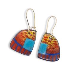 These multicolored statement earrings are remind me of butterfly wings.  Multiple layers of enamel and multiple firings were needed to make this design, each color getting its own firing.  I like the combination of blues, reds, and yellow don't you?   They have high quality brass ear wires handformed by me that clasp so you never have to worry about losing them!   What is enamel?   Enamel is made by fusing multiple layers of glass to a prepared metal at a very high heat.  Each earring requires b Multicolor Enamel Jewelry With Ear Wire, Artistic Enamel Drop Earrings, Artistic Design Enamel Drop Earrings, Orange Enamel Earrings Nickel Free, Blue Enamel Earrings With Artistic Design, Artistic Enamel Dangle Earrings, Nickel-free Orange Enamel Earrings, Artistic Enamel Earrings Nickel-free, Multicolor Enamel Earrings