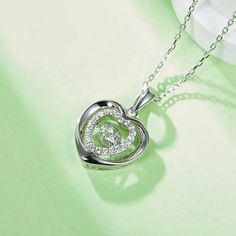 An eye-catching round moissanite dances with ease at the center of this appealing women's necklace, expressing your unstoppable love. Additional round gem set in sterling silver frame the center. Features Moissanite was originally found in meteorites(Chemical name: Silicon Carbide). It was first discovered in 1893, while a scientist was examining meteor samples from a crater in Arizona. After many years, the experts has been recreated moissanite in the laboratory, that make the gemstone with fri Double Heart Necklace, Women's Necklace, Silicon Carbide, Moissanite Necklace, Stone Material, Moissanite Jewelry, Round Moissanite, Double Heart, Timeless Jewelry