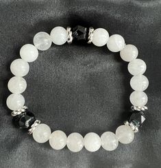 White Jade Bracelet with black Czech glass accents. Stones are 8mm and strung on durable stretch cord. Description card included. Jade - Increases love and nurturing  - Protective stone  - Attracts good luck and friendship - Reases negative thoughts and soothes the mind - Promotes self-sufficiency  - Stimulates ideas - Aids in emotional release, especially irritability How to measure your wrist: -If you don't have a tape measure, wrap a string around your wrist and then measure it with a ruler. Adjustable White Jade Beaded Bracelets, Glass Bead Bracelet Ideas, White Jade Bracelets With Round Beads, White Jade Jewelry With 8mm Beads, White Spiritual Jade Bracelets, Hand-strung White Jade Beaded Bracelets, Emotional Release, Glass Bead Bracelet, How To Measure Yourself