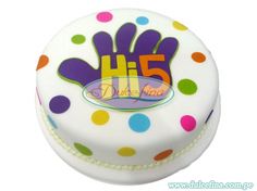 a white cake with multicolored polka dots and the number fifteen on it's side