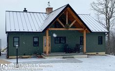 a green house with a metal roof in the snow