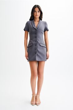 Suit-ableThe PAOLINA Collared Suiting Mini Dress is a chic and sophisticated addition to your wardrobe. Featuring a V neckline with a collar and lapel, it exudes timeless elegance with a hint of modern flair. The functional center front button closure adds a touch of polish, while the non-functional front pockets offer a stylish detail. With short sleeves, it's perfect for warm-weather wear, and the mini length adds a flirty touch to the ensemble. Whether dressed up with heels for a formal occas Weather Wear, V Neckline, Warm Weather, Latest Fashion Trends, Timeless Elegance, Latest Fashion, Dress Up, Short Sleeves, Shop Now