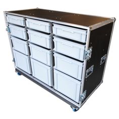 a large black and white storage unit with six drawers on wheels, all stacked up against one another