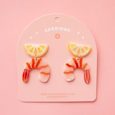 On a pink background is a pair of shrimp cocktail and lemon shaped acetate earrings with a straight back post. Polymer Clay Grape Earrings, Fish Clay Earrings, Aquatic Earrings, Dnd Earrings, Unique Earrings Weird, Weird Earrings Aesthetic, Chilli Earrings, Pickle Earrings, Fun Earrings Unique