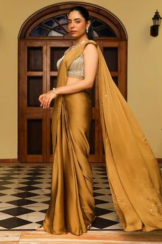 Honey gold pre-draped saree with embellishment on the pallu. Paired with a heavy dori and cutdana embellished blouse. - Aza Fashions Designer Silk Draped Saree, Gold Floor-length Pre-draped Saree With Cutdana, Bollywood-style Draped Wedding Blouse Piece, Silk Designer Wear Draped Dupatta, Silk Dupatta For Designer Wear, Designer Silk Draped Dupatta, Silk Blouse Piece With Draped Sleeves For Wedding, Traditional Wedding Saree With Draped Sleeves, Elegant Draped Dress For Diwali