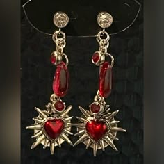 Add A Touch Of Elegance To Your Outfit With These Stunning Sacred Hearts Dangle Drop Earrings. Handmade With Care, They Feature Delicate Hearts That Dangle Gracefully With Blood Red Gem Accents. Perfect For Any Occasion, They Are Sure To Draw Compliments And Make A Lasting Impression. Gothic Heart Art, Red Jewelry Earrings, Red Heart Accessories, Red Silver Jewelry, Gold Red Jewelry, Red And Silver Aesthetic, Red Wedding Accents, Regal Earrings, Blood Earrings