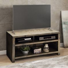 an entertainment center with a flat screen tv on top