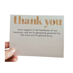 a hand holding up a thank card that says, thank you your support is the background of our business and we're uniquely grateful for the trust