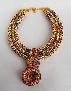 This necklace is 100% handcrafted using multi color beads. Perfect for African themed events. Measurements; 20 inches 18 inches(middle strand) 16 inches. 4 inch pendant. More neckleces here; https://www.etsy.com/shop/TribalTess?ref=seller-platform-mcnav&section_id=21306083 Back to my shop; https://www.etsy.com/shop/TribalTess?ref=seller-platform-mcnav Multicolor Polished Bead Choker Jewelry, Multicolor Polished Beads Choker Jewelry, Multicolor Polished Bead Choker, Multicolor Polished Beads Choker, Multicolor Double Strand Beaded Necklace With Large Beads, Multicolor Small Beads Multi-strand Jewelry, Handmade Double Strand Beaded Necklaces, Multicolor Double Strand Necklace With Large Beads, Double Strand Polished Bead Necklaces