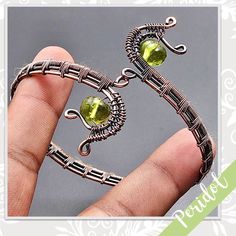 Peridot Quartz Eclectic Copper Wire Wrapped Artisan Cuff Bangle (Lime Green) Style: Boho, Gypsy, Bollywood, Ethnic, Festival, Hippie, Artisan, Handcrafted, Handmade Metal: Plated Copper Features: Wire Wrapped Bracelet Design With Scrolls & Three-Tiered Woven Band Main Stone: Peridot Quartz, Rounded (Lime Green) Created In / Purchased From: Jaipur, India Size: Adjustable From My Worldwide Collection Of New & Vintage Eclectic, Boho Treasures. Favorites Include Designs From Israel, India & Native Americans. Been Collecting For Decades, More To Come! U-9684 Wire Wrapped Cuff Bracelet, Wire Wrapped Bracelet With Stones, Celtic Wire Jewelry, Wig Jig, Wrap Bracelet Tutorial, Wrapped Bracelets, Wire Wrap Bracelet, Wire Wrap Jewelry Designs, Nugget Bracelet