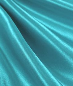 a close up view of a teal green fabric