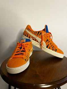 This PUMA Suede x Frosted Flakes Low sneaker is a must-have for any sneaker collector or fan of Tony the Tiger. The shoe features a bright orange color and low-top shaft style, making it perfect for a variety of activities such as cycling, basketball, and skateboarding. It is available in size 6.5 for both men and women. The sneaker is made of suede material and has a PUMA X product line. It also comes with a style code of 388018-01 and was released in 2022. This athletic shoe is suitable for various performance and activities such as golfing, hiking, and walking. Don't miss out on adding this unique and stylish sneaker to your collection! Orange Sneakers With Gum Sole For Streetwear, Orange Sneakers With Boost Midsole For Streetwear, Orange Low-top Sneakers With Boost Midsole, Orange Lace-up Sneakers For Jogging, Orange Sneakers With Laces For Jogging, Orange Low-top Sporty Sneakers, Sporty Orange Low-top Sneakers, Orange Sporty Basketball Shoes With Rubber Sole, Orange High-top Skate Shoes For Streetwear