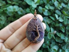 "Amethyst Tree Of Life Pendant - choose a unique gift for any occassion: Mothers Day, Fathers Day, Valentine's Day, Thanksgiving Day, Graduation, Copper Anniversary, Birthday, Christmas, New Year etc. This Tree Of Life Pendant is made of copper wire and natural Amethyst. The pendant is oxidized and polished. Any tarnishing that occurs naturally over time can be easily polished away with a silver polishing cloth. This Amethyst Pendant is made in a wire wrap technique. You will get it in a kraft b Amethyst Amulet Jewelry As Gift, Amethyst Amulet Jewelry For Gifts, Mystical Amethyst Necklace For Gift, Purple Amulet Necklaces As Gifts, Handmade Amethyst Crystal Necklace For Gift, Purple Amulet Jewelry As A Gift, Purple Amulet Jewelry As Gift, Purple Amulet Style Jewelry Gift, Handmade Crystal Necklaces As A Gift