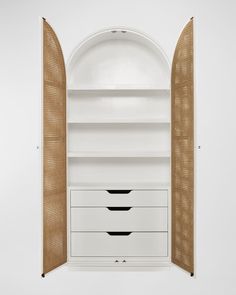 an open white bookcase with three drawers