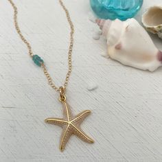 Calling all ocean lovers! This gorgeous golden starfish is perfect for you. Set off your summer tan with a gorgeous enamel accented starfish charm accented beautifully with 3 blue topaz stones. Starfish charm measures approximately 1 inch in diameter. 14kt gold fill chain accented with genuine blue topaz stones. Shell Charm Necklace, Coastal Jewelry, Bee Studs, Summer Tan, Seashell Jewelry, Starfish Necklace, Blue Topaz Stone, Seashell Necklace, Sea Star