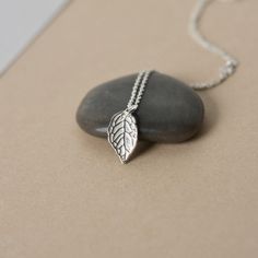 This minimalist charm necklace is perfect for everyday wear! It features a beautifully detailed sterling silver leaf that has a lovely bright shine and polish to it. The leaf is about 14mm long and 9mm wide and it hangs from dainty sterling silver cable chain. The simple design and nature inspired theme make this necklace a versatile accessory and it looks great alone or paired with others for a chic layered look. The necklace is fastened with a sterling spring ring clasp and you can choose your Sterling Silver Everyday Necklace With Nature-inspired Style, Everyday Sterling Silver Nature-inspired Necklace, Everyday Nature-inspired Sterling Silver Necklace, Silver Leaf-shaped Necklaces For Gift, Silver Leaf-shaped Necklace For Gift, Silver Leaf-shaped Necklace Gift, Everyday Sterling Silver Leaf Jewelry, Minimalist Sterling Silver Leaf Jewelry, Everyday Silver Necklace With Nature-inspired Style